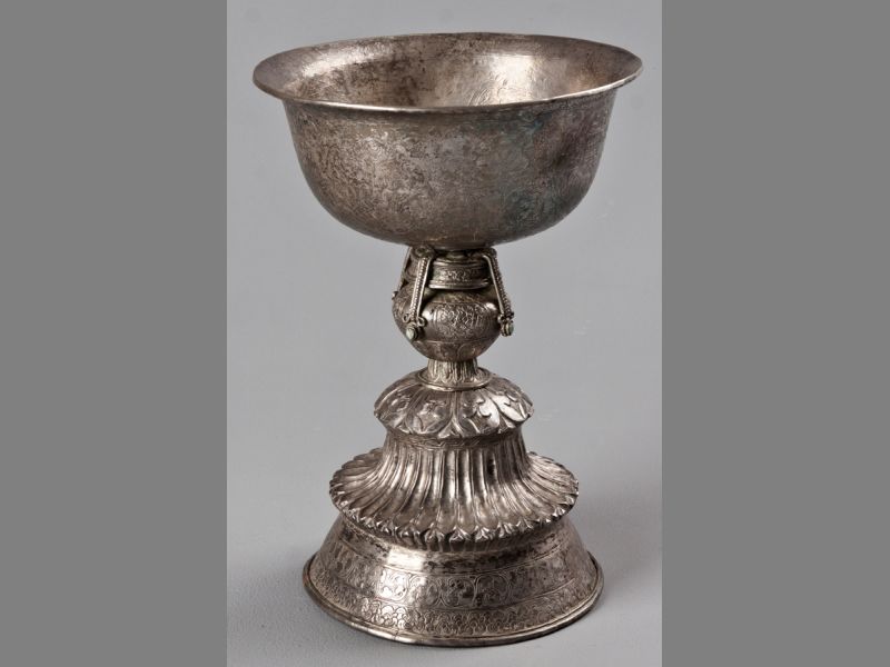 AN 18TH/19TH CENTURY SINO-TIBETAN SILVER STANDING ALTAR CUP, the upper-section of bowl form engraved