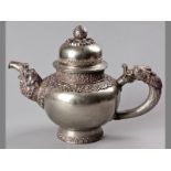 AN IMPOSING 19TH CENTURY SINO-TIBETAN MONKS TEAPOT, of ovoid form, the body decorated with cut-
