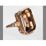 A 9CT YELLOW GOLD AND TOPAZ RING, topaz of square form on a solid shank, 2.1 by 1.8cm.