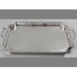 A FRENCH SILVER TWIN-HANDLED GALLERY TRAY, beaded rim, the border decorated with cut-outs of