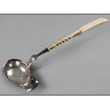 A CONTINENTAL SILVER TODDY LADLE, ivory handle and shell decoration, 35.5cm long.