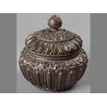 A 19TH CENTURY TIBETAN SILVER COVERED SUGAR BASIN, finely cast wiith lappets aournd the body, the