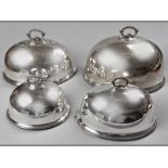 A GRADUATED SET OF FOUR SHEFFIELD-PLATE MEAT DOMES, removable beaded handle, body engraved with