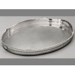 A SILVERPLATE OVAL GALLERY TRAY, gadrooned rims and cut-out border, plain well, standing on four