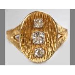 AN 18CT YELLOW GOLD AND DIAMOND RING, three claw-set brilliant cut diamonds on an oval organic