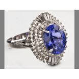 A PLATINUM, TANZANITE AND DIAMOND RING, centre claw-set tanzanite surrounded by seventy-eight