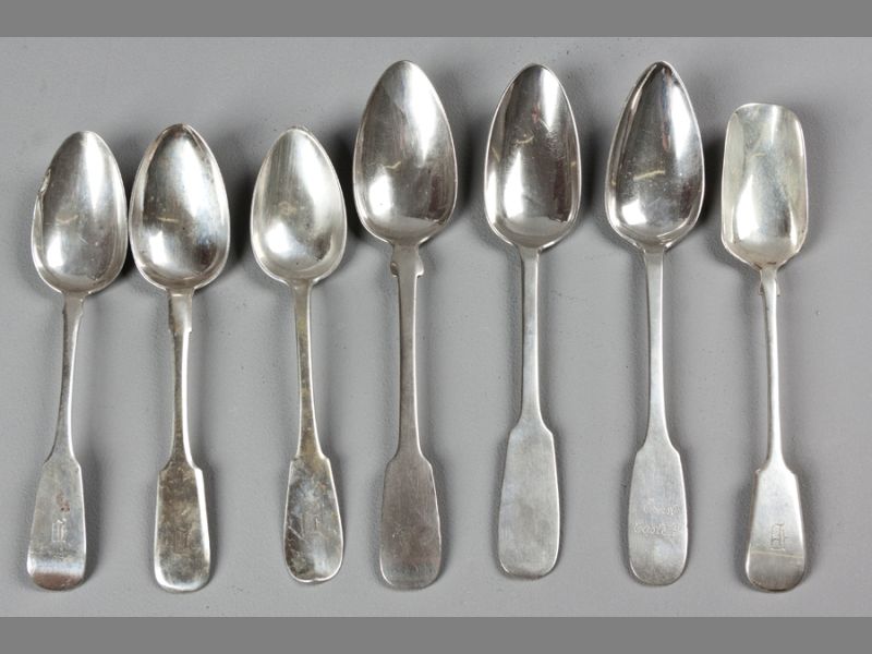 A COLLECTION OF SEVEN 19TH CENTURY CONTINENTAL AND RUSSIAN SILVER FIDDLE PATTERN SERVING SPOONS,