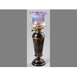 AN ENGLISH MID-VICTORIAN OIL LAMP, CIRCA 1870, the black glazed body decorated with gilding, the