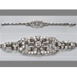 AN 18CT WHITE GOLD AND DIAMOND BRACELET, tube-set centre diamond, surrounded by channel set