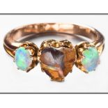 A 14CT YELLOW GOLD AND OPAL RING, centre set with a heart shaped Australian opal, flanked by two