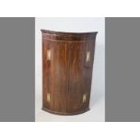 A LATE 18TH CENTURY ENGLISH MAHOGANY HANGING CORNER CABINET, of quarter-round form with a moulded