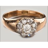 AN 18CT YELLOW GOLD AND DIAMOND CLUSTER RING, nine claw-set diamonds in floral form ending in a