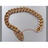 A 9CT YELLOW GOLD BRACELET, solid curb-link, every alternate link engraved, with an engraved heart