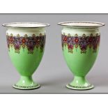 A PAIR OF ROYAL WORCESTER VASES, decorated with a mint green body colour with a deep band of