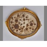 A VICTORIAN 15CT YELLOW GOLD MOMENTMOIRE, oval locket decorated with floral collage in a robe and