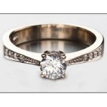 AN 18CT WHITE GOLD AND DIAMOND RING, centre claw-set brilliant cut diamond with diamond shoulders