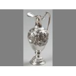 A CONTINENTAL SILVER CLARET JUG, C-scroll handle embossed with leaves, spout with fold-over rim, the