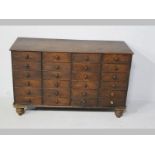 A VICTORIAN TEAK MULTI-DRAWER CABINET, the moulded top above twenty-four short drawers with wooden