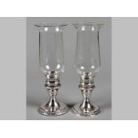 A PAIR OF STERLING SILVER HURRICANE LAMP CANDLESTICKS, with cut-out decorations, terminating on a