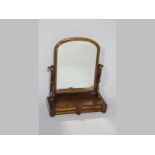 A VICTORIAN MAHOGANY DRESSING MIRROR, the rectangular plate supported on cyma brackets, the