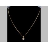 A DIAMOND PENDANT, round brilliant cut diamond in claw setting, together ith a 9ct yellow gold