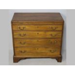 A GEORGE III MAHOGANY CHEST OF DRAWERS, the flush top inlaid with checker banding above a brushing