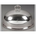A SILVERPLATE MEAT DOME, removable floral form handle, plain body with engraved armoral of a