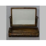 A VICTORIAN MAHOGANY DRESSING MIRROR, the rectangular plate supported on cyma brackets, the