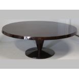 A PIERRE CRONJE MAHOGANY CIRCULAR DINING TABLE, the well figured top with a cantered edge,