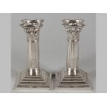 A PAIR OF SILVERPLATE CORINTHIAN COLUMN CANDLESTICKS, by Mappin & Webb, removable wax pans,
