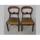 A PAIR OF VICTORIAN MAHOGANY BUSTLEBACK DINING CHAIRS, with let-in seats, standing on turned