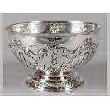 A VICTORIAN SILVER BOWL SHEFFIELD 1898, J.D.W.D, fold-over rim, body embossed with flowers and swags