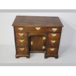 A GEORGIAN MAHOGANY KNEE-HOLE DESK, the moulded top with re-entrant corners above a single long