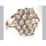 AN 18ct YELLOW GOLD AND DIAMOND RING, nineteen round brilliant cut diamonds claw set in a cluster