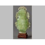 A VERY FINELY CARVED 19TH CENTURY CHINESE GREEN JADE VASE AND COVER, the body of the vase crisply