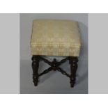 A CONTINENTAL MAHOGANY STOOL, the square upholstered top supported on four turned tapering legs,