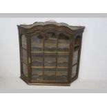 AN 18TH CENTURY OAK DISPLAY CABINET, the arched pediment above a panelled glazed door and sides with