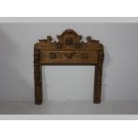 A LATE 19TH CENTURY CONTINENTAL OAK FIRE PLACE SURROUND, the heavily carved pediment with masks,