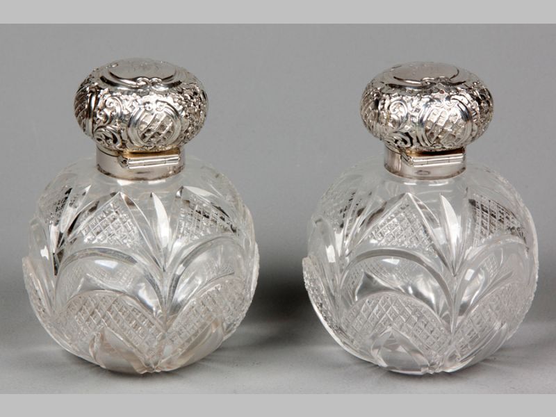 A PAIR OF VICTORIAN CUT-GLASS AND SILVER TOP PERFUUM BOTTLES, CHESTER 1896, MAKERS MARKS