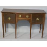 AN EDWARDIAN MAHOGANY SIDEBOARD, the serpentine top above a short drawer flanked by two cupboard
