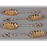 A SET OF FOUR SILVERPLATE BERRY SPOONS, handles realistically moulded in the form of a branch