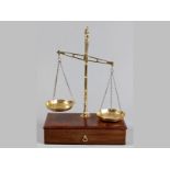 A VICTORIAN BRASS SCALE, by W.T. Avery, Birmingham, mounted on a mahogany box, incorporating a