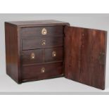 A REGENCY MAHOGANY COLLECTORS CABINET, the single door opening to reveal five drawers of differing