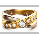 AN 18ct YELLOW AND WHITE GOLD AND DIAMOND RING, centre round brilliant cut diamond in square tube