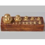 A BOXED SET OF SOLID BRASS WEIGHTS, graduated from 1kg to 10kg, (13).