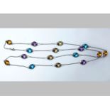 A 14ct WHITE GOLD AND NATURAL STONES NECKLACE, faceted oval amethysts, citrine, blue topaz and