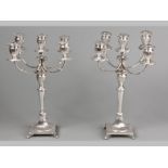 A PAIR OF .800 STD SILVER FIVE LIGHT CANDELABRA, comprising of four branches, each terminating in