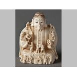 AN EARLY 20TH CENTURY JAPANESE CARVED IVORY NETSUKE, of workmen carving a large Buddha figure, 5cm