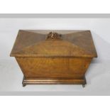 A REGENCY POLLARD OAK WINE COOLER, of sacophagus form, the faceted lid with a heavily carved bunch