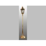 A BRASS STANDING LAMP, in the form of a street lamp, the top with removable finial, terminating on a